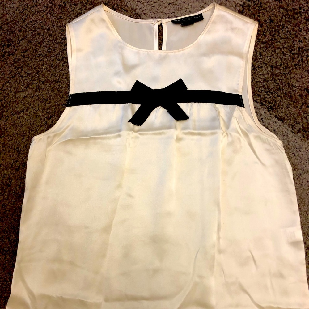 Sleeveless blouse w/ bow detail. Holiday ready!